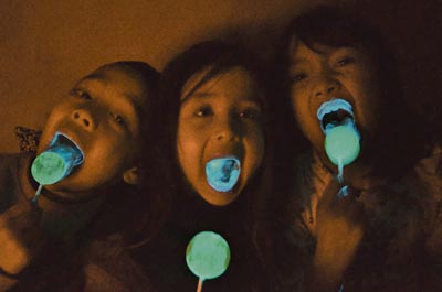 Kids enjoying the lolipop that lights up when they lick it
